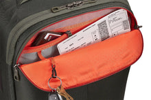 Load image into Gallery viewer, Close up to the front panel's pocket unzipped with a wallet and a boarding pass tucked in, and a set of keys clipped to they key sling.