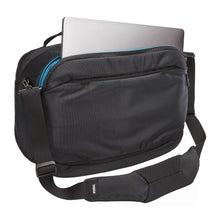 Load image into Gallery viewer, Angled back panel view of the black back with a laptop peeking from the compartment.