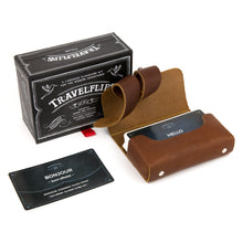 Load image into Gallery viewer, The French Travelflips box arranged with the included cards inside the included leather case.
