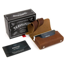Load image into Gallery viewer, The French Travelflips box with the cards arranged inside the included leather card case.