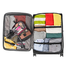 Load image into Gallery viewer, Interior view of the suitcase filled with clothes and travel accessories. The main compartment's items are held with the adjustable straps.