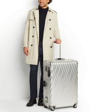 Load image into Gallery viewer, A young man wearing a light beige trench coat, holding the packing case by the extended telescopic handle.