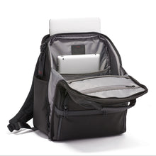 Load image into Gallery viewer, Angled front view of the backpack with the main compartment opened. A laptop is peeking from the back panel, A tablet is placed inside a pocket.