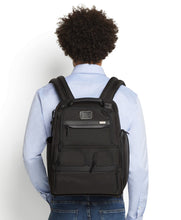 Load image into Gallery viewer, A young man facing the background carries the backpack on his back with the shoulder straps.