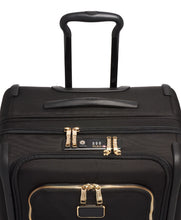 Load image into Gallery viewer, Angled top panel view of the suitcase. It features a grab handle, and a TSA approved three-digit combination lock.