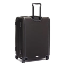 Load image into Gallery viewer, Angled back panel view of the black suitcase with the telescopic handle extended.