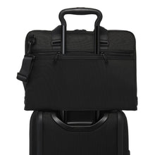 Load image into Gallery viewer, A suitcase's telescopic handle passed through the briefcase's back strap to hold it in place.