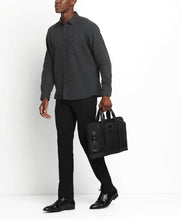 Load image into Gallery viewer, A young man holding the briefcase by the grab handles.