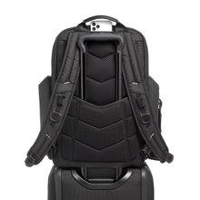Load image into Gallery viewer, Back panel view of the backpack, featuring adjustable shoulder straps, a phone compartment under the top grab handle, and an attachment band. A telescopic handle passed through the band to hold the backpack in place.