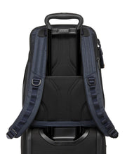 Load image into Gallery viewer, Back panel view with the attachment strap holding the backpack to a suitcase's telescopic handle.