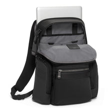 Load image into Gallery viewer, Angled front panel view of the black backpack with a laptop peeking from the back panel's compartment. The main compartment is unzipped and folded down.