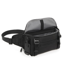 Load image into Gallery viewer, Angled front panel view of the black sling bag with the main compartment unzipped.