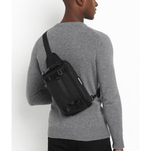 Load image into Gallery viewer, A young man carrying the sling bag on his back