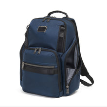 Load image into Gallery viewer, Angled front panel view of the blue backpack with the side pocket unzipped.