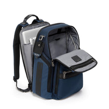 Load image into Gallery viewer, Angled front panel view of the blue backpack with the back panel and front panel's unzipped. The back panel features a laptop and tablet compartment.