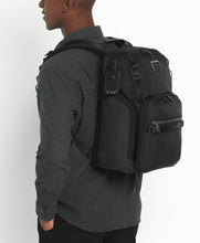 Load image into Gallery viewer, A young man wearing a gray shirt carrying the backpack on his back with the shoulder traps.