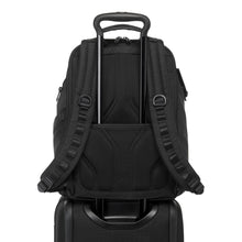 Load image into Gallery viewer, Back panel view of the backpack showing the attachment strap. The telescopic handle of a suitcase is passed through it to hold the backpack in place.