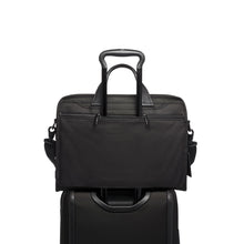 Load image into Gallery viewer, The briefcase being held to a suitcase's extended handle by the attachment strap.