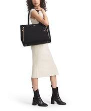 Load image into Gallery viewer, A young woman wearing a beige dress holding the bag on her shoulder.