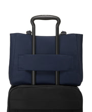Load image into Gallery viewer, Back panel view with the attachment strap holding the bag onto a suitcase's telescopic handle.