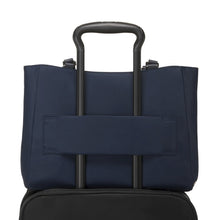 Load image into Gallery viewer, Back panel view with the attachment strap holding the bag onto a suitcase's telescopic handle.