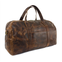 Load image into Gallery viewer, Angled front view of the brown distressed leather duffle bag.