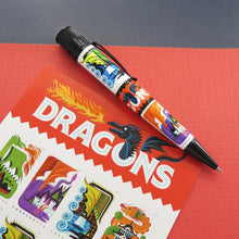 Load image into Gallery viewer, Side view of the pen laid on a card with cartoon dragons on post stamps.