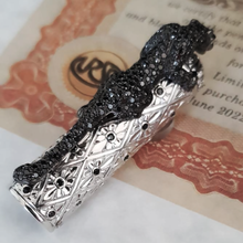 Load image into Gallery viewer, Close up to the cap's clip, laid on top of the included certificate.