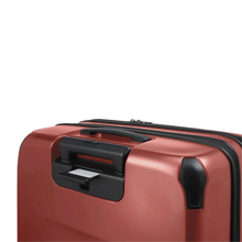 Load image into Gallery viewer, Angled close up to the back of the suitcase. A hidden panel behind the telescopic handle has a tag where you can write your name and contact information.