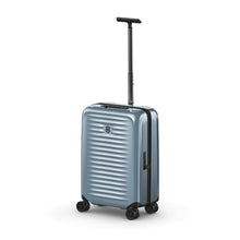 Load image into Gallery viewer, Angled front view of the light blue suitcase with the telescopic handle extended.