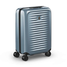 Load image into Gallery viewer, Angled front view of the light blue suitcase with the telescopic handle retracted.