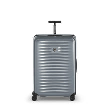 Load image into Gallery viewer, Front panel view of the suitcase with the telescopic handle partly extended.