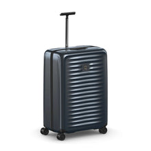 Load image into Gallery viewer, Angled front view of the dark blue suitcase with the telescopic handle extended.