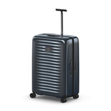 Load image into Gallery viewer, Angled front view of the dark blue suitcase with the telescopic handle extended.