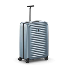 Load image into Gallery viewer, Angled front view of the light blue suitcase with the telescopic handle extended.