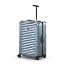 Load image into Gallery viewer, Angled front panel view of the light blue suitcase with the telescopic handle extended.