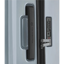Load image into Gallery viewer, Close up to the side panel on the blue suitcase, featuring a grab handle with the Victorinox logo engraved on it, and a TSA approved three-digit combination lock.