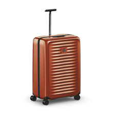 Load image into Gallery viewer, Angled front view of the orange suitcase with the telescopic handle extended.