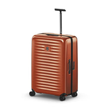 Load image into Gallery viewer, Angled front view of the suitcase with the telescopic handle extended.