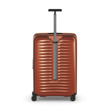 Load image into Gallery viewer, Back panel view of the orange suitcase with the telescopic handle extended.