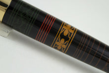Load image into Gallery viewer, Close up to the line designs in green, red, yellow, and brown on the barrel
