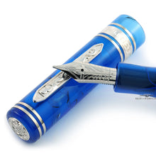 Load image into Gallery viewer, Close up to the fountain pen nib resting on the cap. The clip and nib have engraved decorations.
