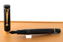 Load image into Gallery viewer, Back view of the fountain pen with the cap set to the side. Placed on top of the wooden presentation box.