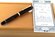 Load image into Gallery viewer, Side view of the fountain pen next to the identity card on top of the wooden presentation box.