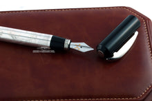 Load image into Gallery viewer, Close up to the fountain pen nib with the cap set next to it.