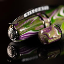 Load image into Gallery viewer, Angled view of the Visconti Homo Sapiens Lotus Garden Fountain pen cap top and bottom of the pen. The cap has a medal on the top with the Visconti logo engraved on it.