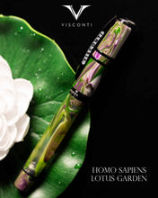Load image into Gallery viewer, The Visconti Homo Sapiens Lotus Garden Fountain Pen laid on a Lilly pad on a black background. The Visconti logo is at the top, and the text HOMO SAPIENS LOTUS GARDEN is at the bottom.