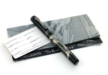 Load image into Gallery viewer, The pen placed on top of the pamphlet and ID card. Laid on a white background.