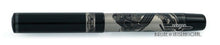 Load image into Gallery viewer, Back view of the fountain pen with the cap on, closed. The cap has a silver ring with decorations and text engraved. It reads: Erotic Art Pen.