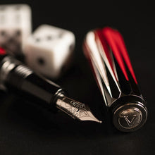 Load image into Gallery viewer, Angled close up to the nib and cap top of the Visconti Backgammon Fountain Pen. The Visconti logo is engraved at the top of of the cap medal.